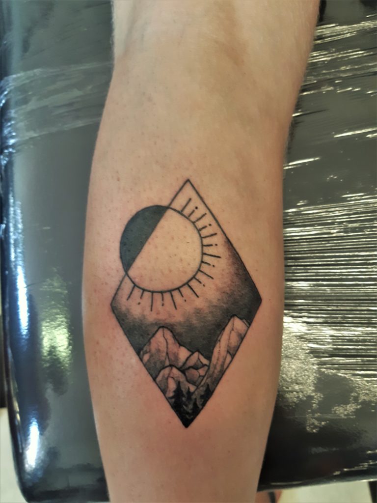 geometric sun and mountain tattoo from our tattooshop
