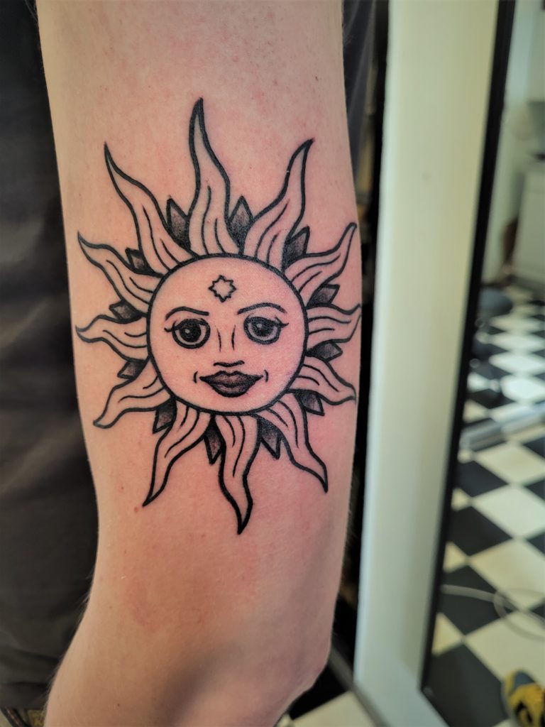 sun tattoo arm