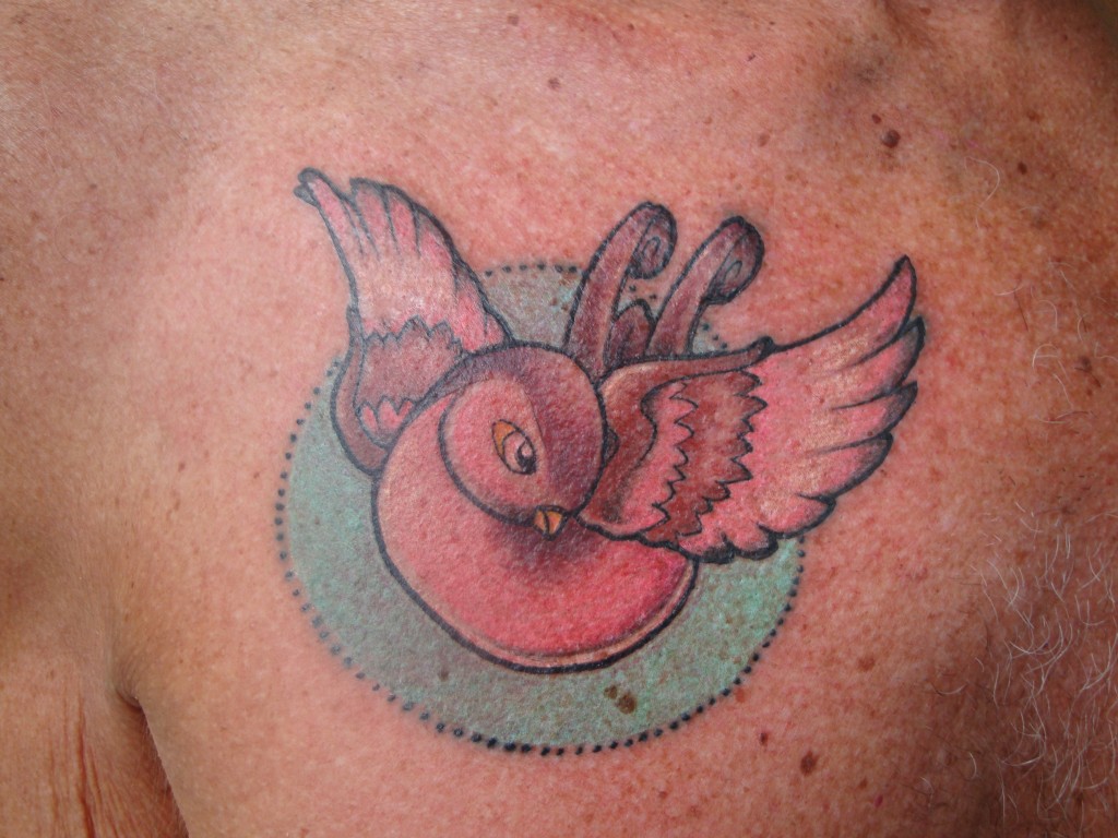 Newschool swallow tattoo in full candy-colours.
