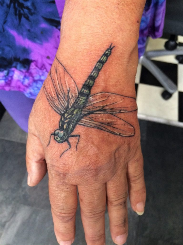 dragonfly hand tattoo inked at our tattooshop